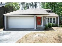 Charming one-story home with a bright red front door and attached garage at 1110 Elmira Ave, Durham, NC 27707