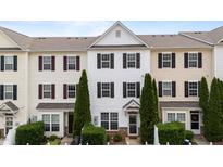 Charming townhouse featuring a white facade, black shutters and well-maintained landscaping at 1120 Renewal Pl # 111, Raleigh, NC 27603