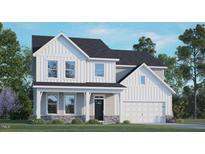 Charming two-story home featuring vertical siding, stone accents, covered porch and attached two-car garage at 123 Pony Gallop Ln, Clayton, NC 27520