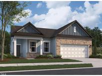 Charming exterior elevation of a two-story home with a brick and siding facade and an attached garage at 124 N Keatts Winner Ct, Wilson's Mills, NC 27520