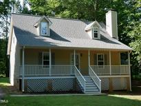 Charming two-story home with a welcoming front porch, dormer windows, and manicured lawn at 129 Clark Ct, Youngsville, NC 27596