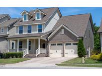 Charming two-story home with a welcoming front porch and a two-car garage at 1600 Drift Falls Ln, Wendell, NC 27591