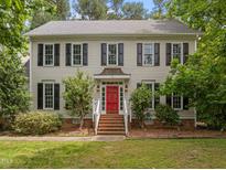 Charming two-story home with black shutters and a red front door at 18 Acornridge Ct, Durham, NC 27707