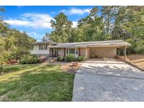 Charming home featuring a carport and a lush green lawn at 1920 Hillock Dr, Raleigh, NC 27612
