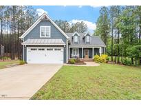 Charming two-story home with a well-manicured lawn and attached two-car garage at 210 Sorrel Dr, Franklinton, NC 27525
