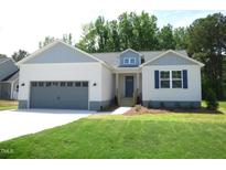 Charming single-story home with a gray two-car garage, blue shutters, and a well-manicured lawn at 235 Eason Creek Way, Clayton, NC 27527