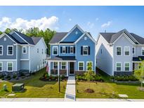 Charming two-story home with blue siding, black shutters, landscaped yard, and inviting front porch at 279 Edge Of Auburn Blvd, Raleigh, NC 27610