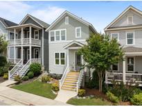 Charming two-story home with light-green and gray siding, complemented by a well-manicured lawn and inviting front porch at 282 Granite Mill Blvd, Chapel Hill, NC 27516