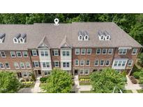 Beautiful brick townhome featuring dormer windows and professionally landscaped front yard at 3109 Stockdale Dr, Raleigh, NC 27609