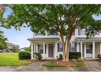 Charming townhome with well-maintained landscaping, inviting entrance, and front porch at 3141 Rapid Falls Rd, Cary, NC 27519