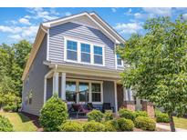 Charming two-story home with a cozy front porch swing and beautiful landscaping at 425 Liberty Hill, Morrisville, NC 27560