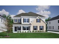 Charming two-story home featuring a blend of siding and brick, complemented by dark shutters and a well-manicured lawn at 50 Guardian St, Youngsville, NC 27596