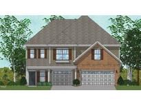 Charming two-story home featuring a brick facade, symmetrical windows and shutter accents, with a gray roof at 50 Guardian St, Youngsville, NC 27596