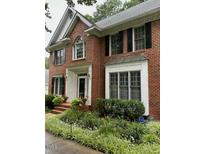 Charming two-story brick home with a well-manicured lawn and classic architectural details at 511 Windstream Way, Cary, NC 27518