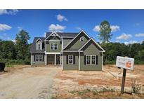 Inviting two-story home with vertical siding, black shutters, and symmetrical design at 55 Livingston Ln, Spring Hope, NC 27882