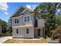 Charming two-story home with gray siding, modern windows, and a well-maintained landscape at 5601 Preston Pl, Raleigh, NC 27604
