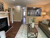 Inviting living room featuring fireplace, modern decor, and an open view to the kitchen at 600 Audobon Lake Dr # One B21, Durham, NC 27713