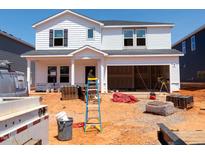 New construction of a two-story home with a large two-car garage in the process of being completed at 740 Deschutes Dr, Garner, NC 27529