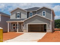 Charming two-story home featuring a two-car garage and classic gray siding at 744 Deschutes Dr, Garner, NC 27529