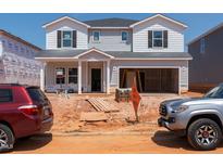 Two-story home under construction with a two-car garage and light gray siding with dark shutters at 748 Deschutes Dr, Garner, NC 27529
