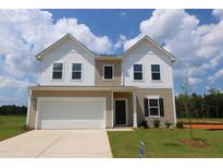 Charming two-story home with a white garage, neutral siding, and a well-manicured lawn at 935 Bombardier Ln, Spring Hope, NC 27882