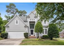 Charming two-story home featuring a well-manicured front lawn, attached garage, and inviting entryway at 100 Wentbridge Rd, Cary, NC 27519