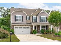 Charming two-story home with stone accents, a well-manicured lawn, and a two-car garage at 1024 Holland Bend Dr Dr, Cary, NC 27519
