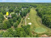 Stunning aerial view of home with a golf course in a lush green neighborhood at 113 Feezor Ct, Clayton, NC 27527