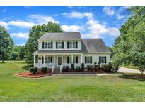Charming two-story home with a welcoming front porch and well-maintained landscaping on a lush lawn at 113 Feezor Ct, Clayton, NC 27527