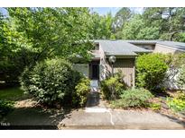 Inviting front entrance with lush landscaping and a well-maintained walkway leading to the front door at 16 Tottenham Ln # 16, Chapel Hill, NC 27517