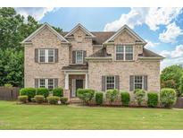 Charming two-story brick home with a manicured lawn and neatly trimmed hedges at 200 Vintage Hill Cir, Apex, NC 27539