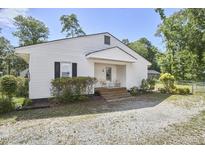 Charming white home featuring a quaint front porch and well-maintained landscaping at 2616 Kirk Rd, Durham, NC 27705