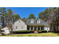Charming two-story home with manicured lawn, covered porch, and attached garage at 2934 Appaloosa Ct, Graham, NC 27253