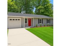 Charming single-story home featuring a red front door, attached garage, and well-maintained lawn at 3204 Winfield Ct, Raleigh, NC 27610