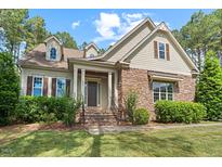 Charming home featuring a stone facade, landscaped front yard, and inviting front porch at 344 Colonial Ridge Dr, Pittsboro, NC 27312