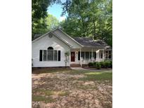 Charming single-story home featuring a red front door and covered porch at 352 Riverstone Dr, Clayton, NC 27527
