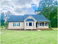 Charming single-story home with well-maintained lawn and mature trees in a desirable neighborhood at 4200 Harmony Church Rd, Efland, NC 27243