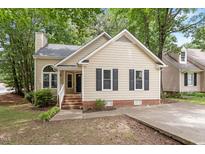 Charming single-Gathering home featuring a brick foundation, neutral siding, and classic black shutters at 4401 Liverpool Ln, Raleigh, NC 27604