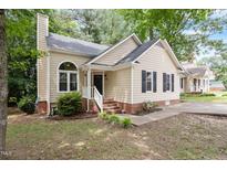 Charming one-story home with a welcoming front porch, landscaped yard, and a well-maintained exterior at 4401 Liverpool Ln, Raleigh, NC 27604