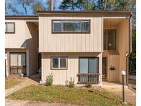 Two-story townhouse exterior features a modern design with multiple windows and a covered porch at 5073 Tall Pines Ct, Raleigh, NC 27609