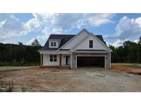 Charming new construction home featuring stone accents and a spacious two-car garage at 55 Stream View Way, Spring Hope, NC 27882
