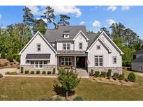 Beautiful home featuring a stone and siding facade, manicured lawn, and a welcoming front porch at 623 Westfall Way, Chapel Hill, NC 27517