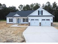 Charming single-story home featuring a two-car garage and a beautifully landscaped front yard at 788 Shade Tree Rd, Benson, NC 27504
