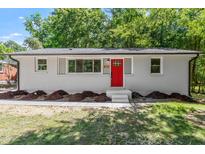 Charming single-story home featuring a bright red front door and freshly landscaped yard at 833 Brigham Rd, Raleigh, NC 27610