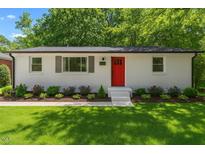 Charming single-story home with a bright red front door and well-manicured landscaping at 833 Brigham Rd, Raleigh, NC 27610