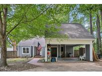 Charming single-story home with a covered carport and an American flag display at 103 Lakeway Ct, Cary, NC 27511