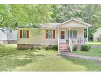 Charming single-story home featuring a cozy front porch and well-maintained landscaping at 109 Grange Dr, Wendell, NC 27591