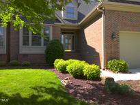 Well maintained brick home with mature landscaping and a manicured lawn at 12 Crail Ct, Durham, NC 27712