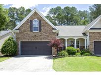 Charming home featuring stone accents, a two-car garage, well-manicured lawn, and a welcoming entrance at 120 Jennel Way, Durham, NC 27707