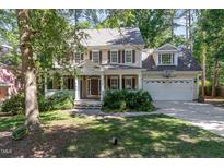 Charming two-story home with a covered front porch, landscaped yard, and a two-car garage at 124 Cypress View Way, Apex, NC 27502